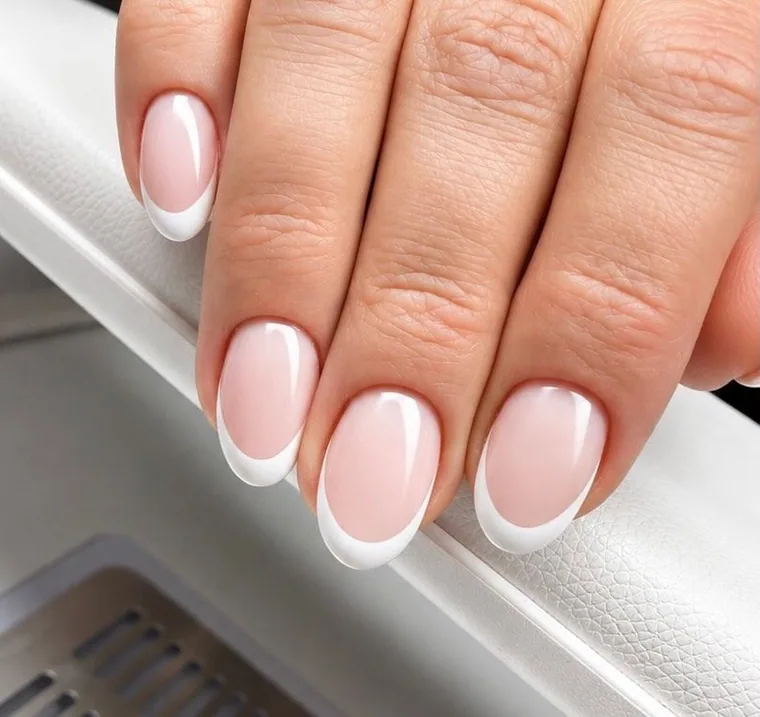Classic white French tips on oval nails